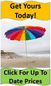 bright rainbow umbrella on beach