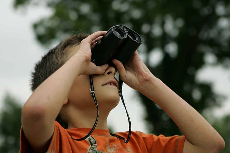 boy using binoculars