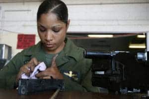 Photo via Yuma on Flickr.com female soldier cleaning machine gun